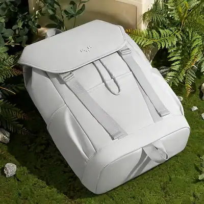 White backpack for women and men designed for travel, school, and everyday use with multiple compartments and adjustable straps for comfort.