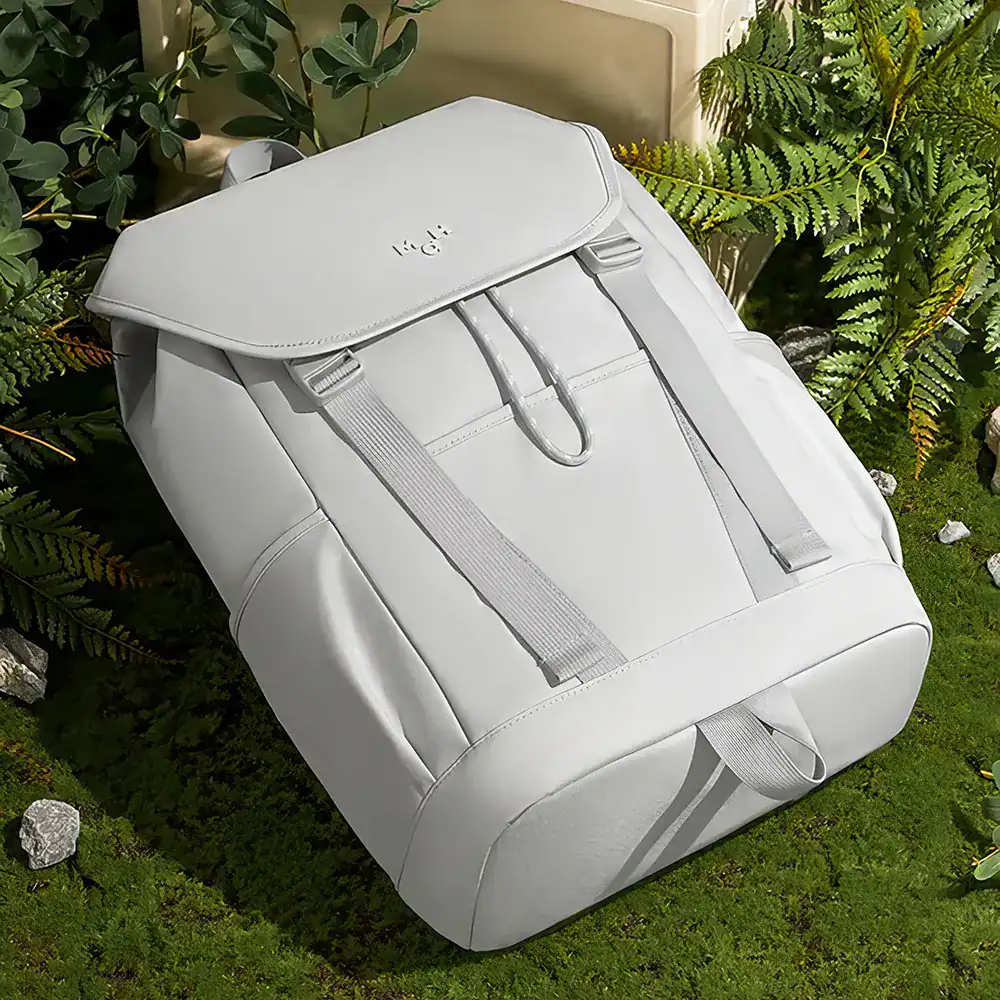 White backpack for women and men designed for travel, school, and everyday use with multiple compartments and adjustable straps for comfort.