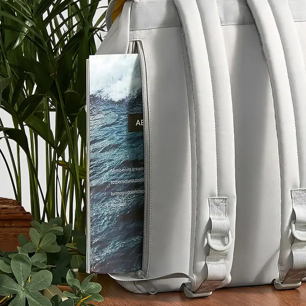Light gray travel backpack featuring ocean wave graphic and zipper pocket, ideal for stylish travelers and daily use.