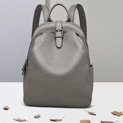 High-quality gray leather backpack with sleek design, durable material, and adjustable straps, perfect for fashion-forward and functional everyday use.