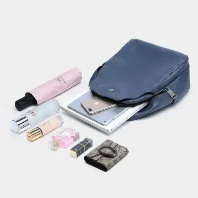 Bright blue handbag with organizer containing phone, tablet, and wallet for daily use and travel.