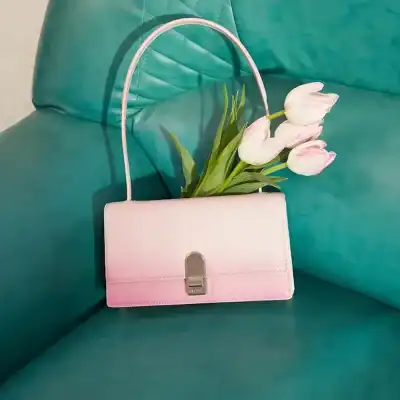 Stylish pink handbag with silver clasp, perfect for fashion and daily use. Made of high-quality materials, offering a sleek design for women’s accessories.