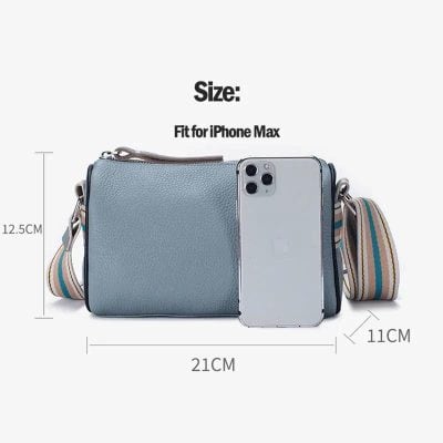 Elegant blue crossbody bag perfect for carrying essentials, compatible with iPhone Max. Dimensions: 21cm x 12.5cm x 11cm, ideal for stylish everyday use and perfect for optical accessories.