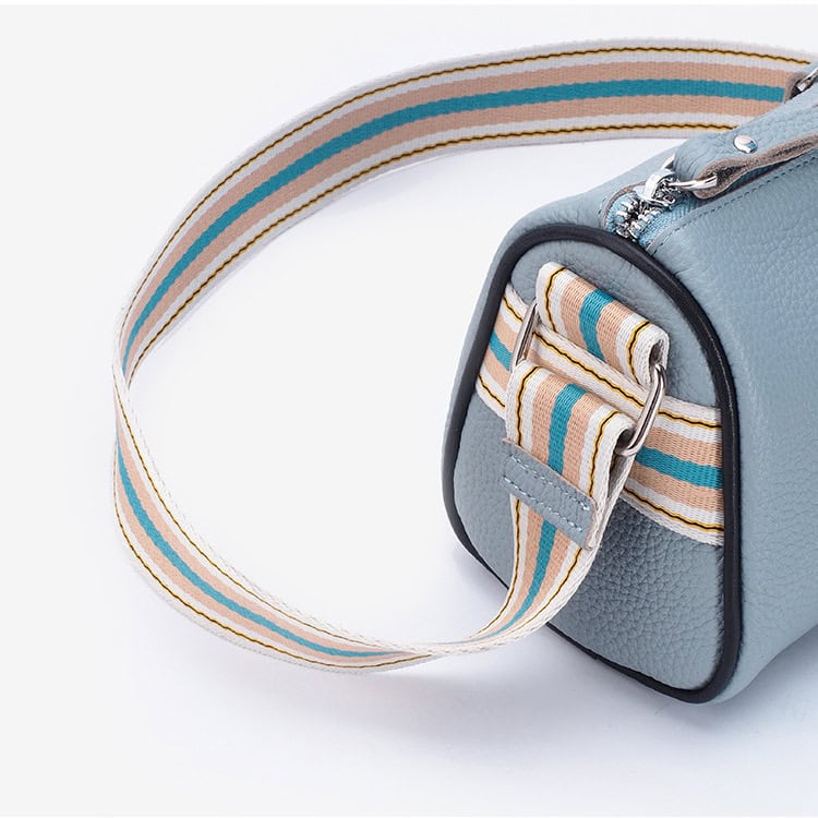 Stylish light blue leather handbag with striped fabric strap, perfect for women’s fashion, casual outings, or accessories. Great for everyday use and enhancing your look.