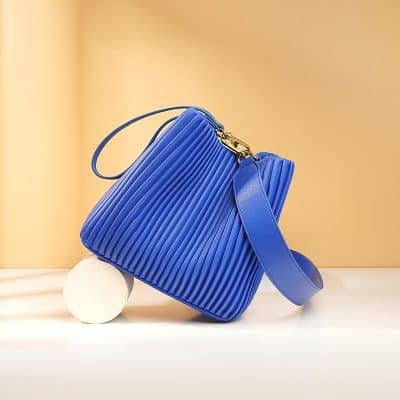 Blue designer handbag with quilted texture and gold hardware, perfect for fashion-forward accessories.
