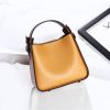 Stylish tan leather handbag with dark brown accents, perfect for fashion-forward accessories. High-quality, trendy and versatile for daily or special occasion use.