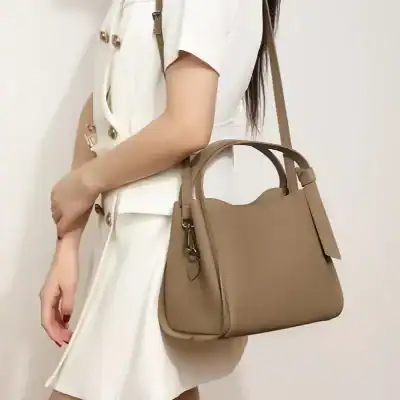 Stylish beige leather handbag for women, perfect for fashion-forward accessories, durable and versatile for everyday use and special occasions.