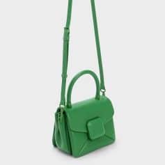 Bright green handbag with adjustable strap, stylish and functional accessory for everyday use, perfect for fashion-conscious women.