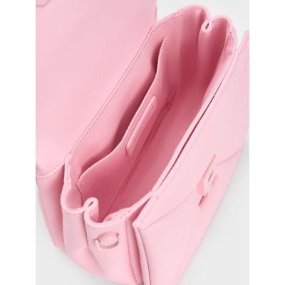 Close-up of pink makeup or cosmetic bag showing multiple compartments and zippers, stylish and functional for organizing beauty essentials.