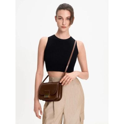 Stylish brown leather crossbody bag with adjustable strap, perfect for fashion-forward women seeking versatile accessories.