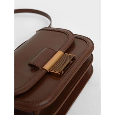 High-quality brown leather handbag with gold-tone hardware, stylish and perfect for daily or special occasions, featuring multiple compartments for organization.