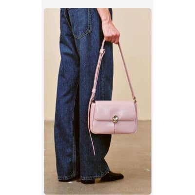 Elegant pink handbag with adjustable strap, stylish design, perfect for daily wear and accessories. Features a secure closure and fashionable look for women.