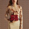 Stylish red leather handbag showcasing a sophisticated and trendy accessory, perfect for enhancing any outfit. Ideal for fashion-conscious women seeking high-end handbags.