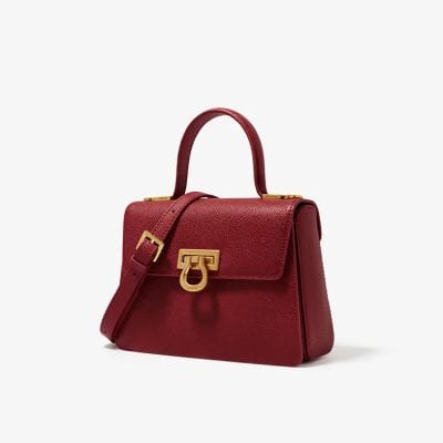 Elegant red handbag with gold accents, perfect for stylish women. Made from premium leather, spacious interior, ideal for fashion accessories and daily use.