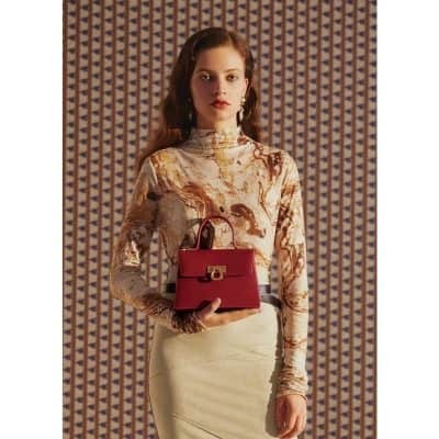 Elegant red handbag with gold hardware showcased at Monalisa Store, perfect for stylish accessories and luxury fashion collections.