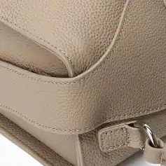 Close-up of a beige leather handbag showcasing textured material and high-quality craftsmanship, ideal for fashion accessories, luxury bags, and stylish handbags SEO purposes.
