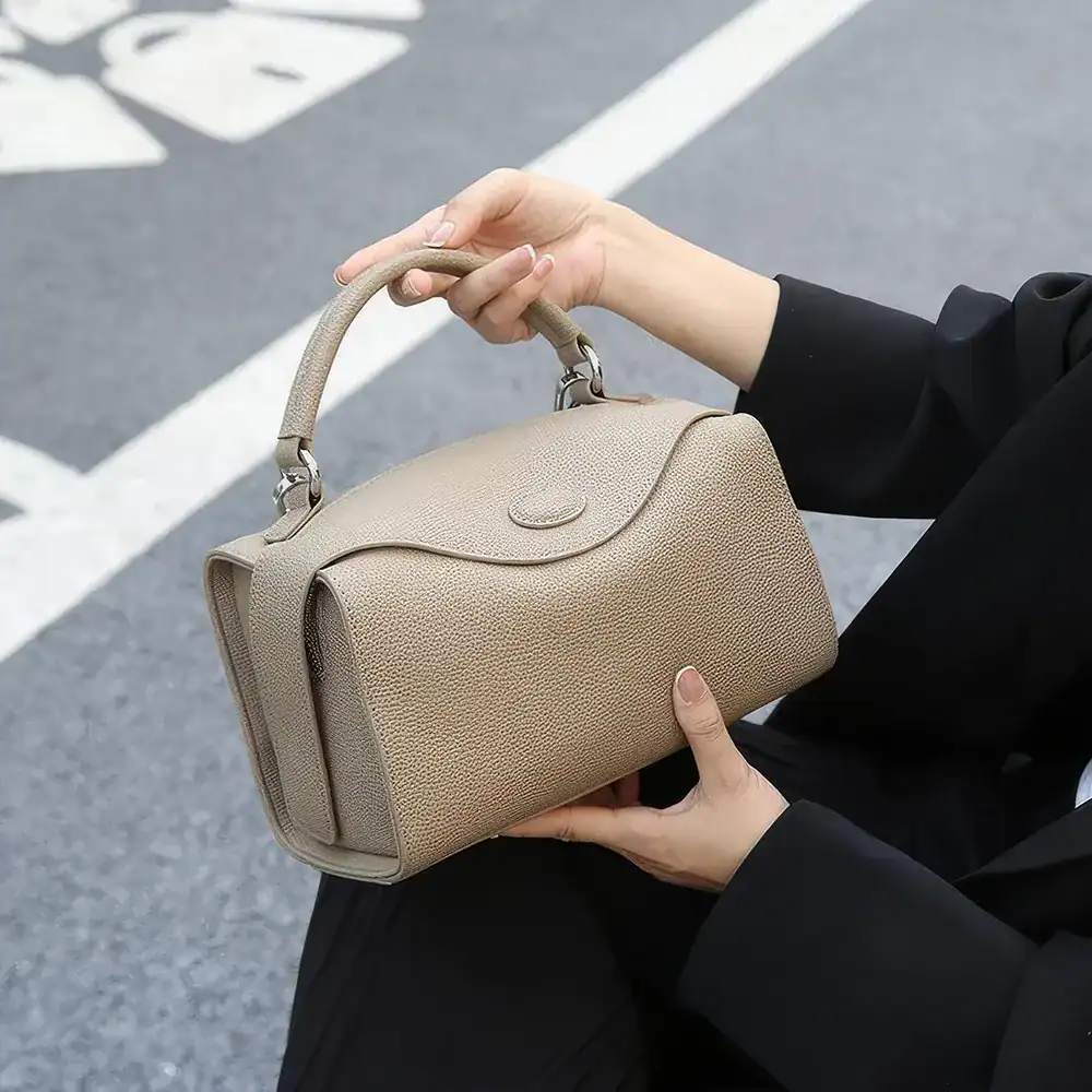 Luxury beige women's handbag with textured leather, ideal for fashion accessories and daily essentials. Perfect for stylish outfits and versatile looks.