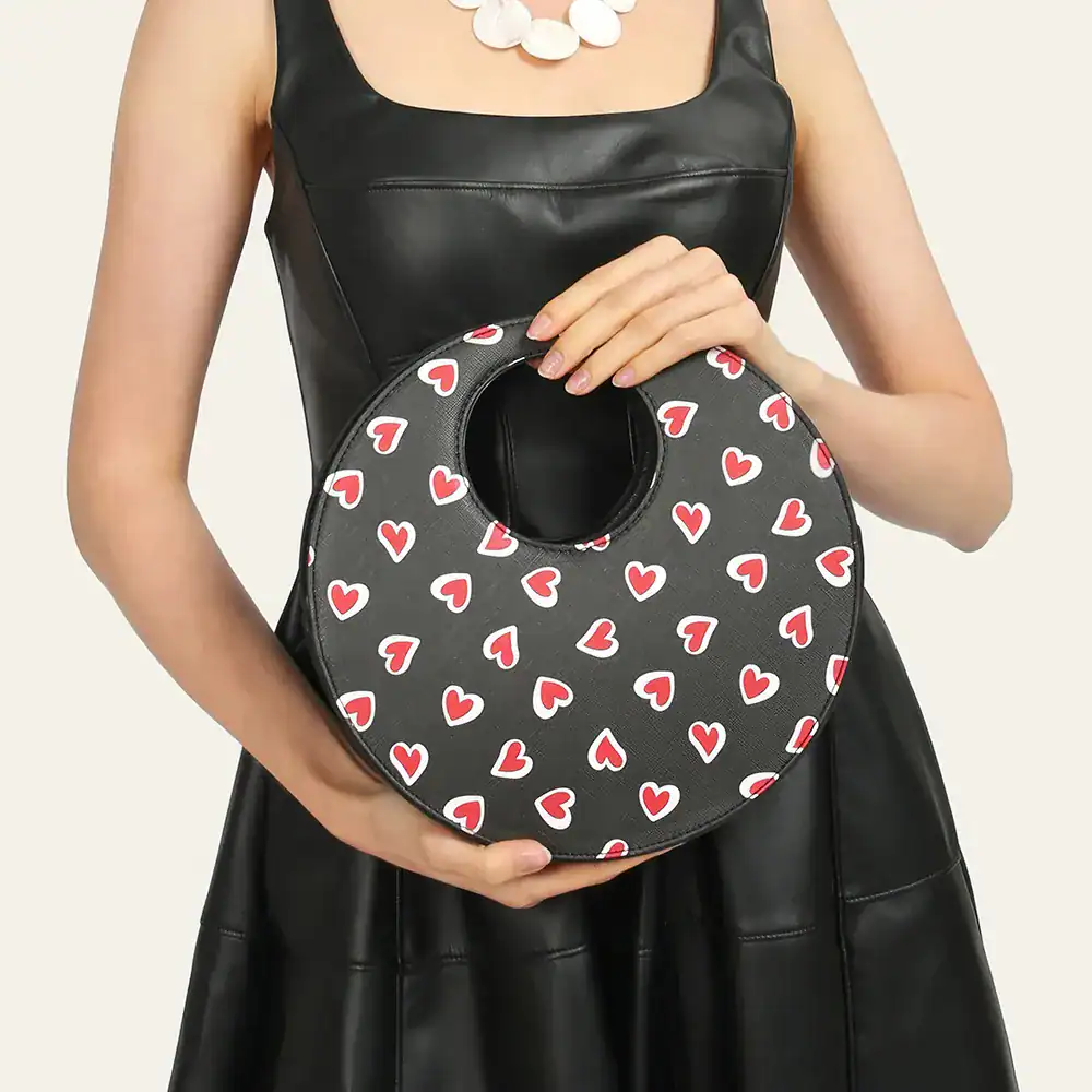 Stylish heart print handbag made of eco-friendly vegan leather, perfect for women’s accessories, designer bags, and casual outings.
