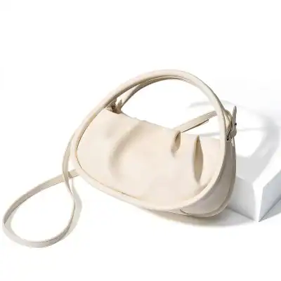 Luxurious white handbag made for women, featuring a modern minimalistic style suitable for all occasions. Durable, lightweight, and perfect to complement any outfit for a chic and elegant look.