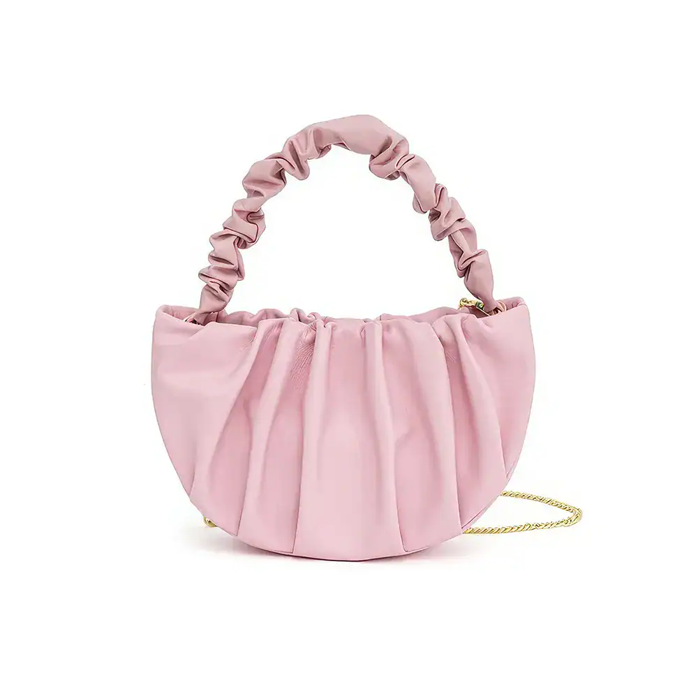 Pink satin handbag with ruched handle and gold chain detail, perfect for fashion-forward accessories and stylish occasions.