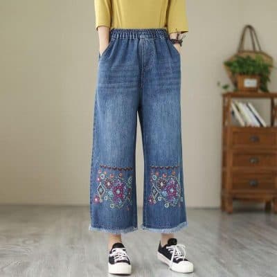 Comfortable wide-leg denim with colorful embroidery and raw hem, perfect for casual and trendy look.