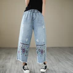 Comfortable distressed denim with colorful embroidery, wide-leg fit, and casual style for trendy looks. Perfect for everyday wear or fashion-forward outfits.