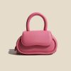 Cute pink handbag with rounded design, spacious for essentials, perfect for fashion-forward accessories lovers.