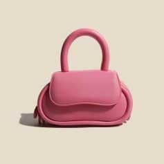 Cute pink handbag with rounded design, spacious for essentials, perfect for fashion-forward accessories lovers.