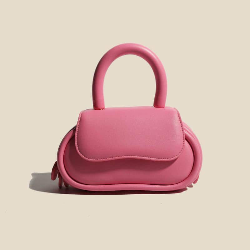 Cute pink handbag with rounded design, spacious for essentials, perfect for fashion-forward accessories lovers.