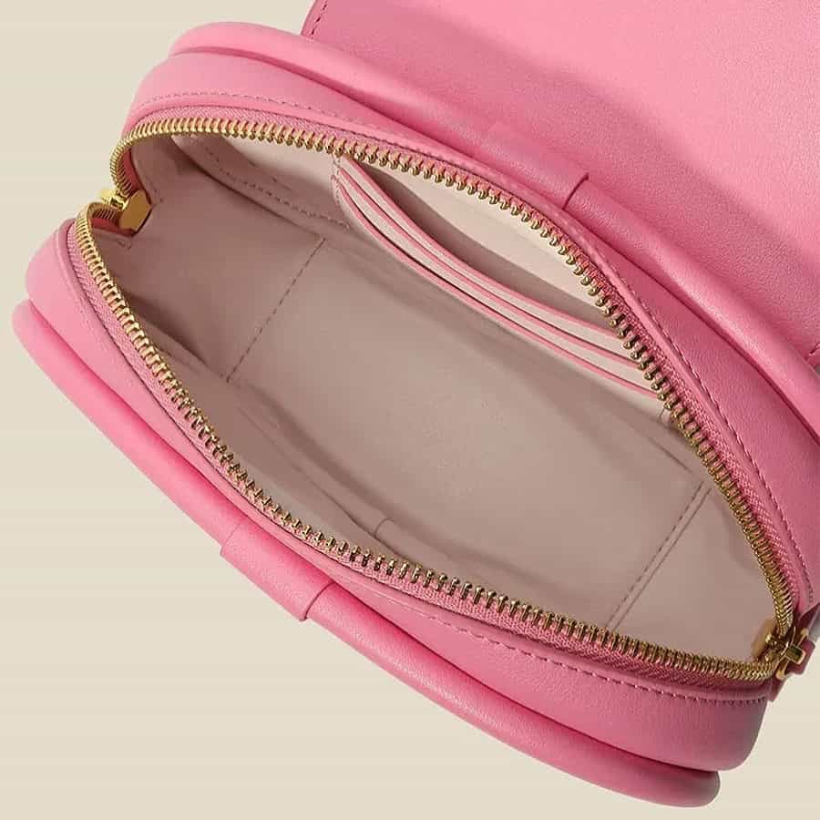 Pink makeup bag with gold zipper, spacious interior with card slot, ideal for cosmetics, skincare, and accessories, perfect for travel, organization, and stylish storage.