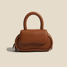 Stylish brown leather mini handbag with top handle, perfect for fashionable accessories and versatile use.