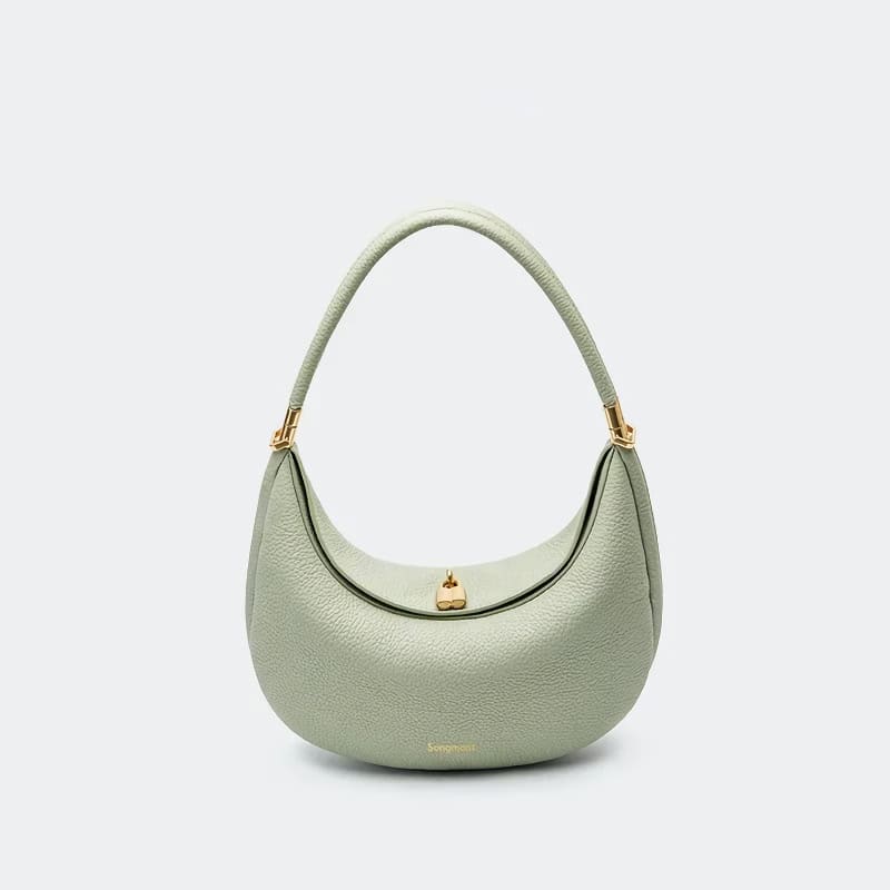 Elegant green handbag with textured leather, gold hardware, and a stylish curved design, perfect for fashion-forward individuals seeking high-quality accessories.