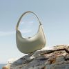 Stylish cream leather handbag for women, perfect for beach or casual outings. Designed with a comfortable strap and spacious interior. Ideal accessory for summer fashion and summer accessories.