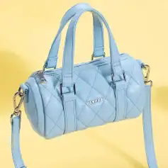 Chic blue designer handbag perfect for fashion-forward women, made with high-quality materials, featuring a quilted pattern, sturdy handles, and versatile strap for day-to-night use.