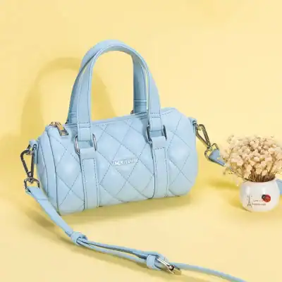 Stylish light blue quilted handbag for women, perfect for fashion and everyday use, featuring durable material and adjustable shoulder strap.