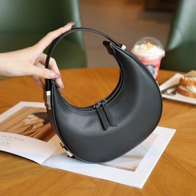 Stylish black leather handbag with modern design, perfect for fashion-forward accessories. Lightweight, versatile, and ideal for daily or evening use.