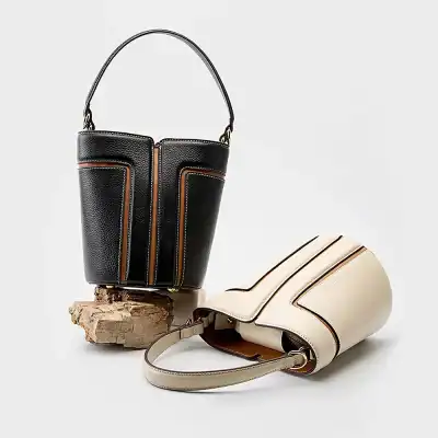 Stylish black and beige leather handbags featuring high-quality craftsmanship, perfect for fashion-conscious women seeking luxury accessories.