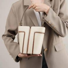 High-quality beige leather handbag with brown accents, perfect for fashion-forward individuals seeking luxury accessories. Classic design suitable for everyday use.