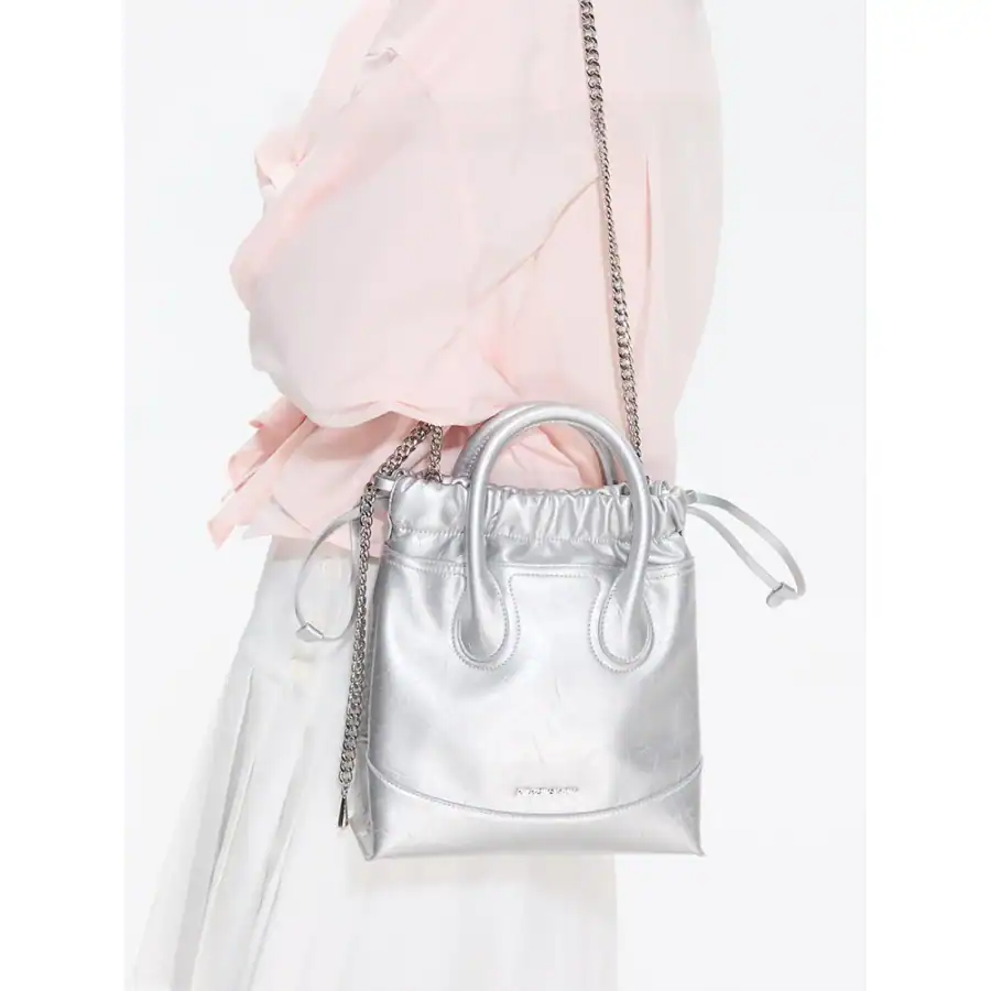 Elegant metallic silver handbag with chain strap and ruched detailing, perfect for fashion-forward accessories and versatile for daily or evening outings.