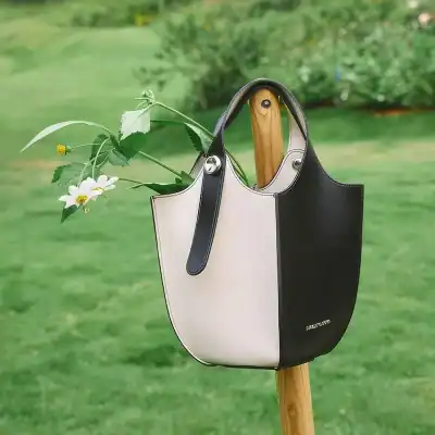 Stylish monochrome handbag designed for optical accessories, featuring premium leather, spacious interior, and sophisticated look for opticians and eyewear lovers.