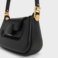 Fashionable black leather handbag with gold hardware, perfect for stylish accessories and daily use. High-quality material, versatile design, ideal for completing any outfit.