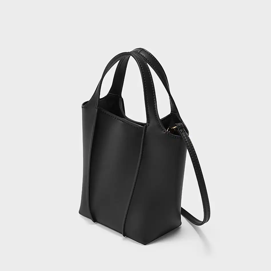 Elegant black leather tote handbag with adjustable strap, ideal for women seeking stylish and functional accessories for everyday use or professional settings.