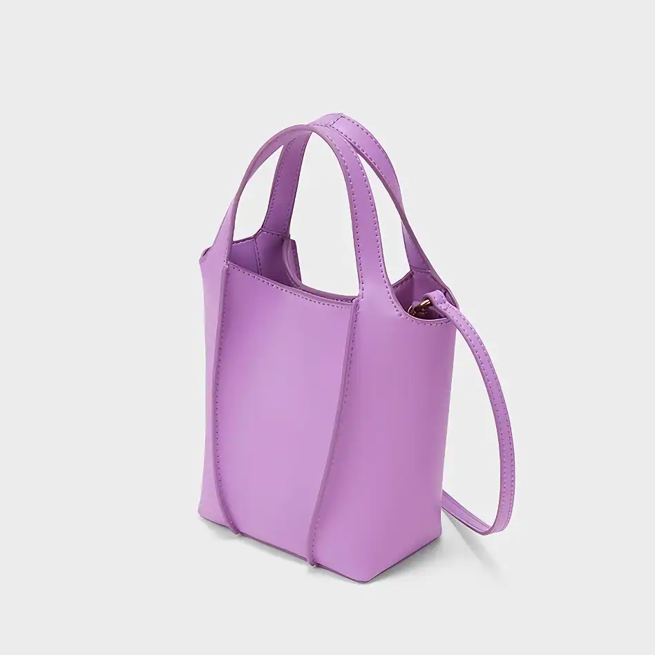 Stylish purple mini tote bag with top handles and an adjustable strap, perfect for casual and elegant occasions. Made with premium materials, offering both fashion and functionality.