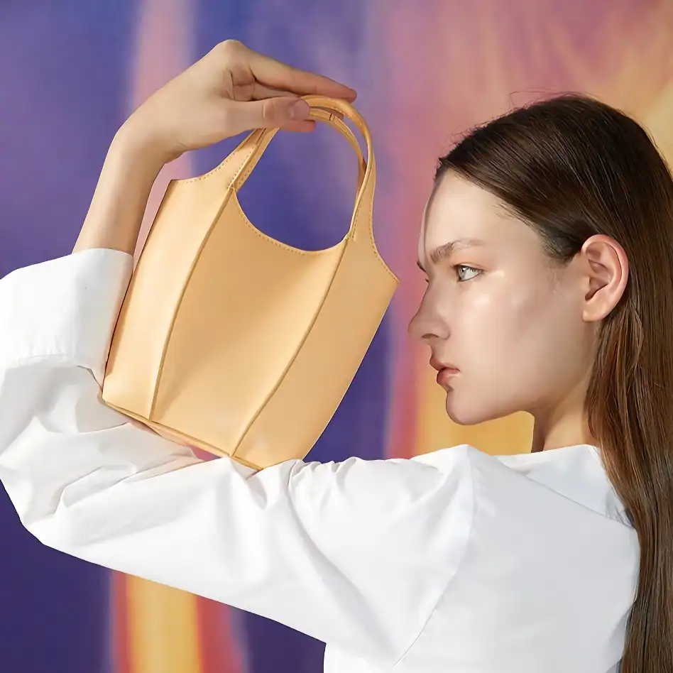 Stylish beige tote bag held by a woman showcasing fashion accessories, perfect for daily use. Great for shopping, work, or casual outings. Made of durable, high-quality material.