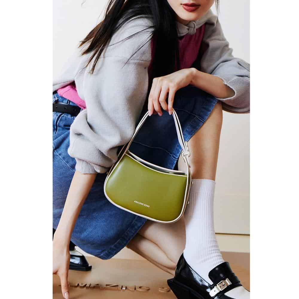 A fashionable green handbag displayed at Monalisa Medical Store showcasing trendy accessories for women. Perfect for style-conscious shoppers seeking quality bags.