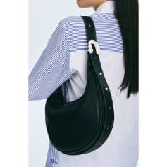 Stylish black shoulder bag from Monalisa Medical Store, perfect for casual outings and daily use, with a modern crescent design and adjustable strap for comfort.