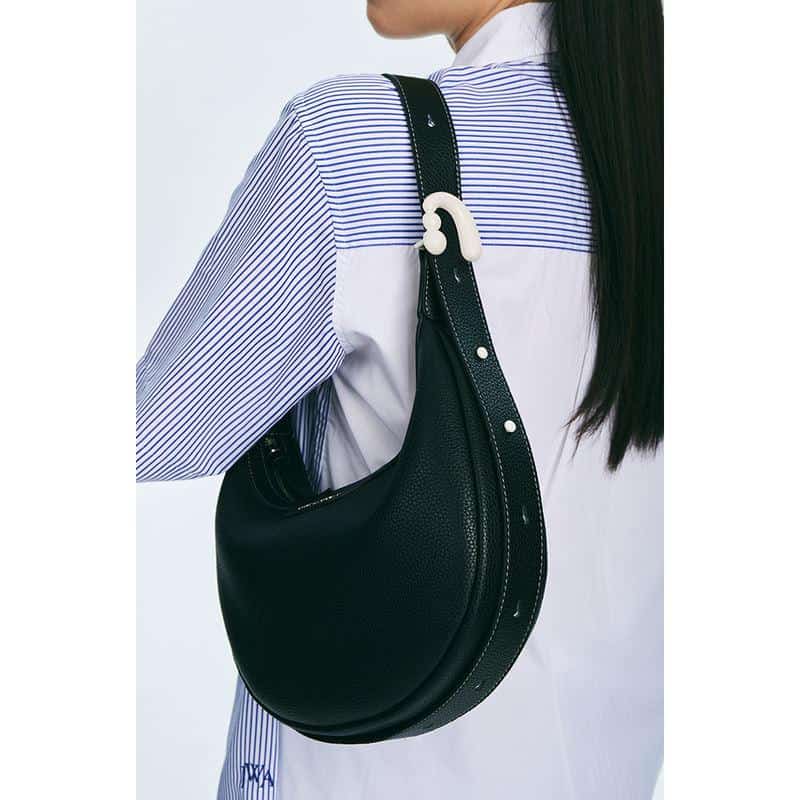 Stylish black shoulder bag from Monalisa Medical Store, perfect for casual outings and daily use, with a modern crescent design and adjustable strap for comfort.