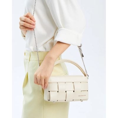 Elegant cream-colored handbag with woven design, perfect for fashionable outings. Features a chain strap and spacious interior for beauty essentials.