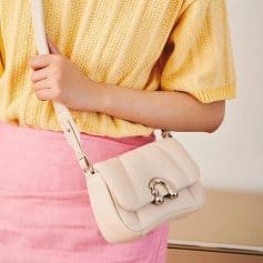 Elegant cream-colored handbag with gold hardware, perfect for stylish women. Compact and trendy, ideal for daily use or special occasions, enhances your fashion statement.