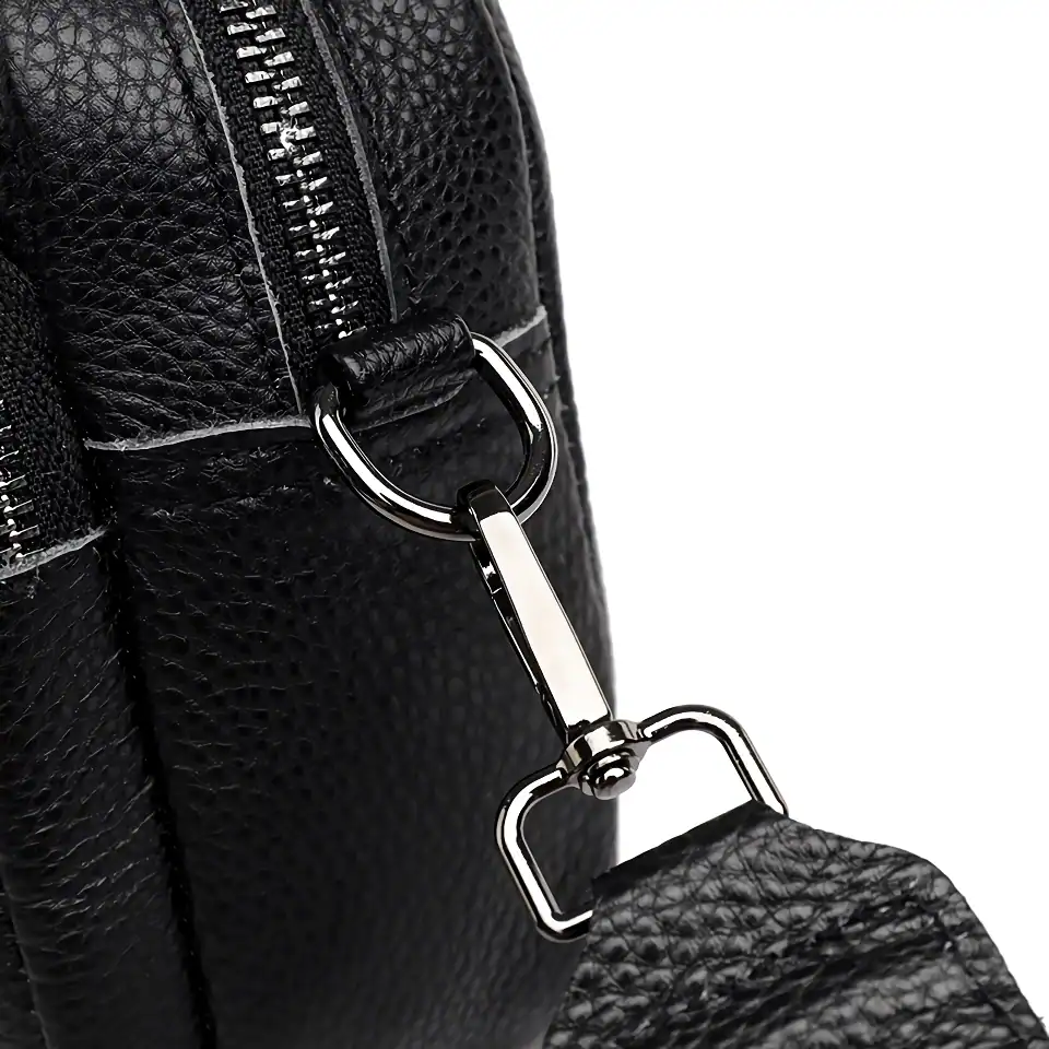 High-quality black leather handbag with durable zipper and metal clasp, perfect for fashion-forward individuals seeking elegant accessories.